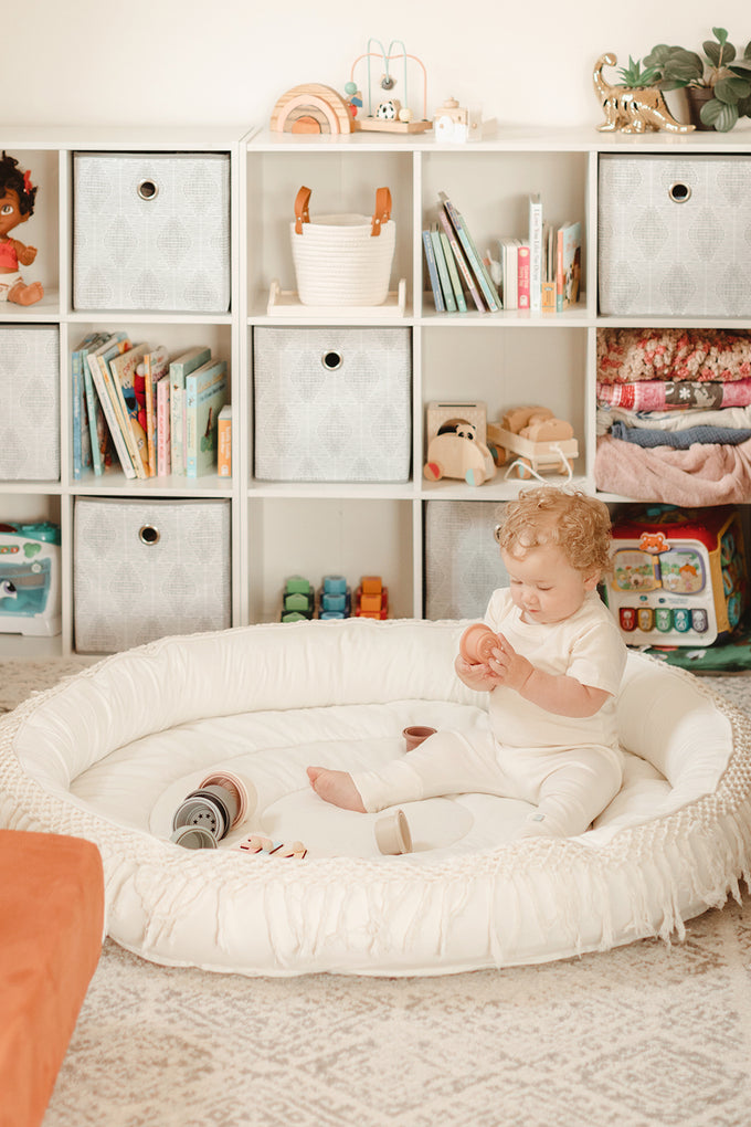 baby sitting in organic play mat